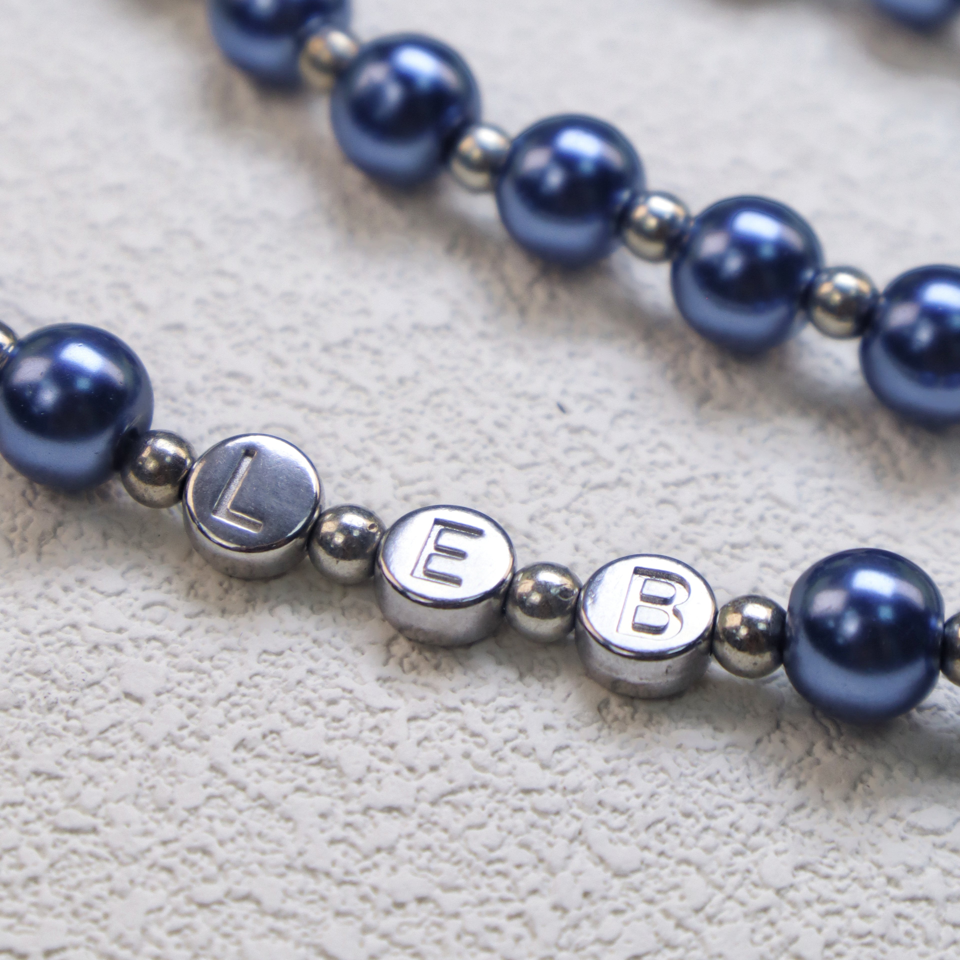 Personalized blue Catholic rosary with elegant prayer beads, religious medals, and silver crucifix designed as a meaningful faith gift.