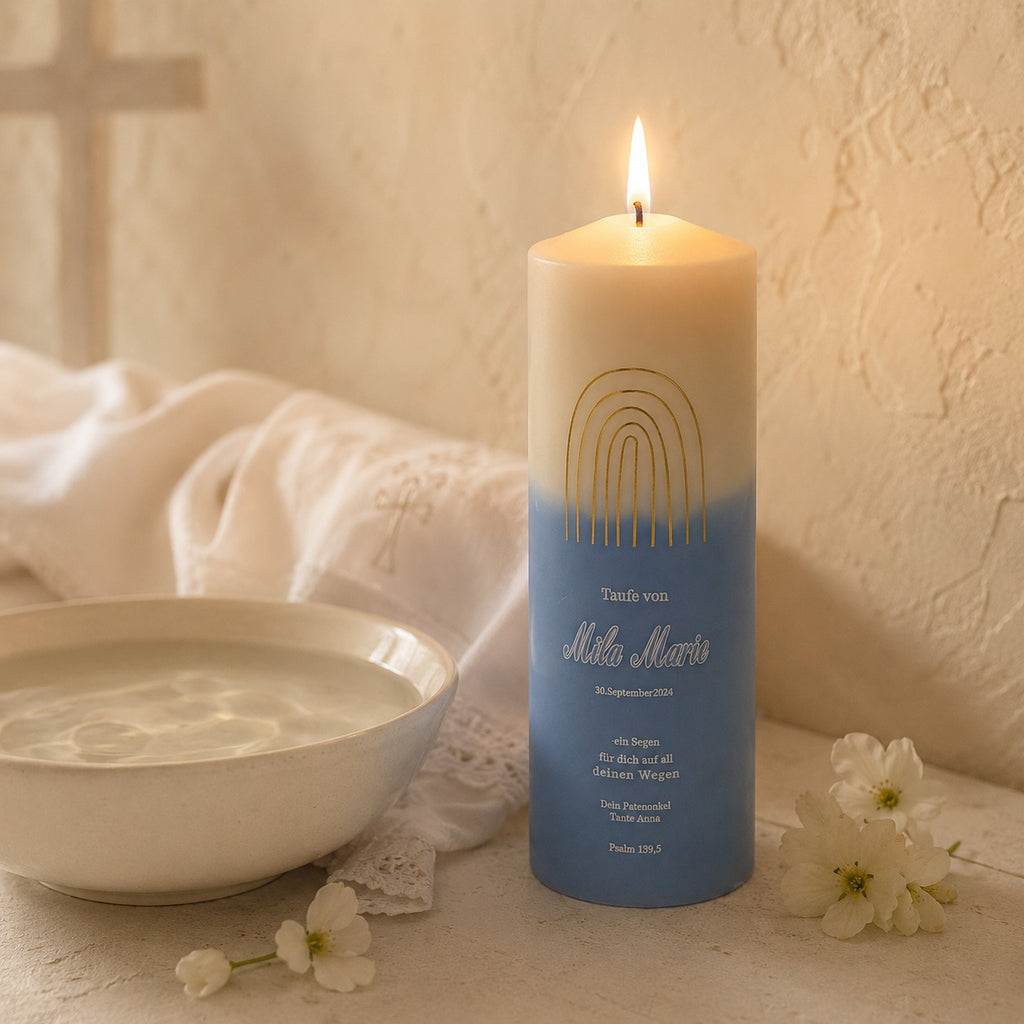 Custom baptism candle displayed with baby’s breath flowers, featuring a dove, rainbow, olive branch design, personalized name, and baptism date