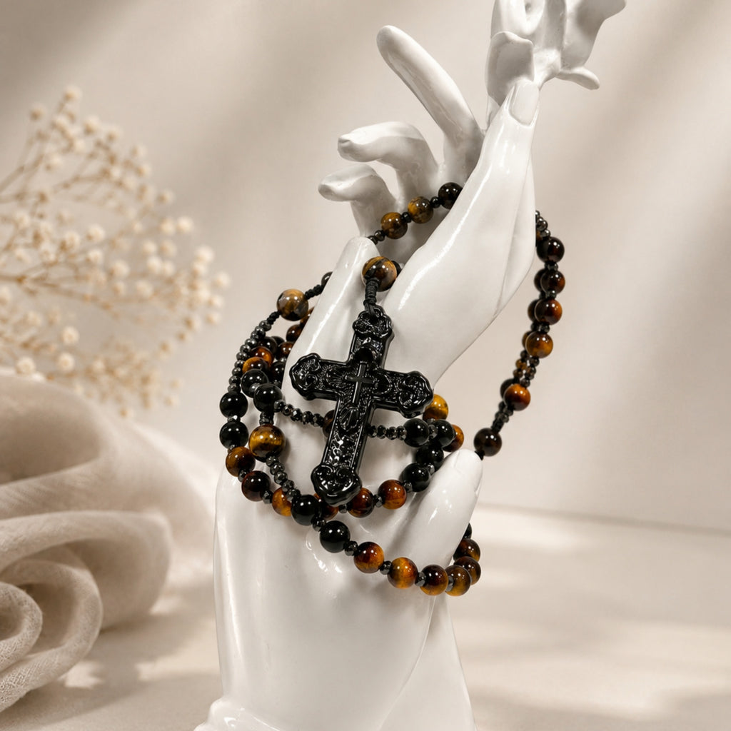 Handmade tiger eye rosary for men featuring black prayer beads, metallic spacers, and a detailed black crucifix