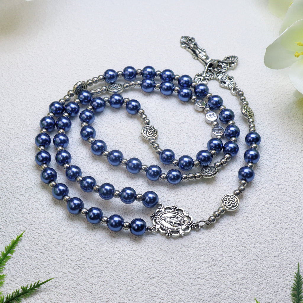 Handcrafted five decade Catholic rosary featuring deep blue prayer beads, silver-tone medals, Marian center piece, and crucifix for personal devotion.