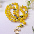 Yellow ladybug Catholic rosary with colorful beads, decorative ladybug charms, and gold-tone crucifix designed for children's prayer and faith gifts.