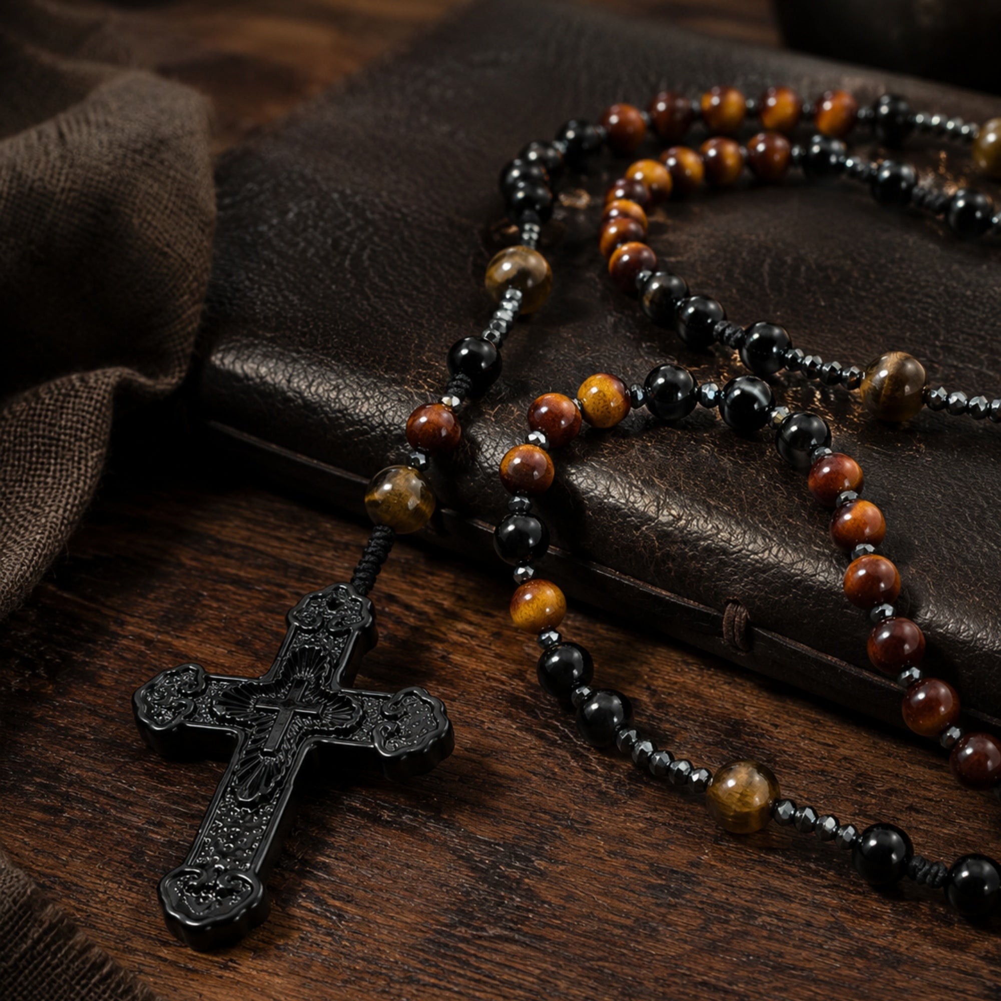 Men’s Catholic prayer beads with tiger eye style beads and black crucifix, styled as a meaningful faith gift for him