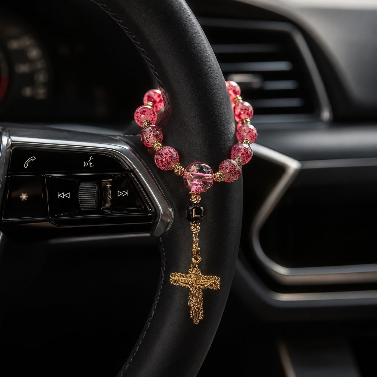 Elegant red Catholic car rosary with textured beads, gold crucifix, and personalized letter bead designed as a faith accessory for drivers